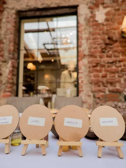 Personalized wooden easels with guest names, ready for the candle-making activity. These little details make each guest feel welcomed and special.