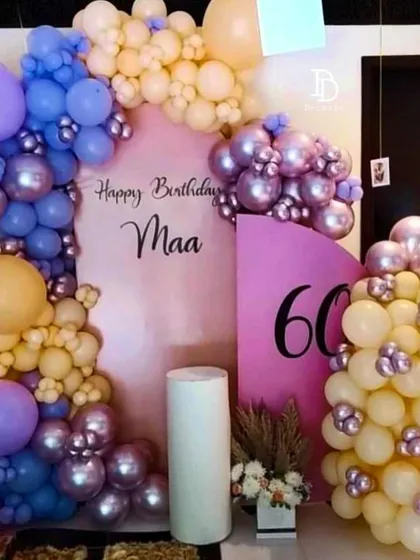 A lovely birthday setup for 'Maa's' 60th, using a soft and unique color palette of pastel yellow, purple, and pink.