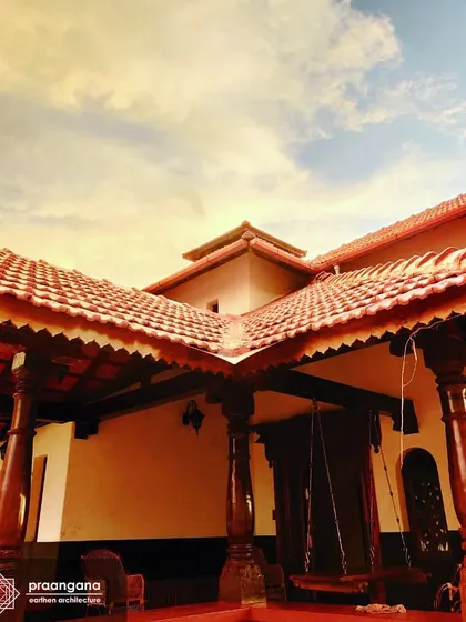 The veranda of the Udupi house, with its traditional wooden pillars and swing ('jhoola'). This is the social heart of the home, a place for conversation, relaxation, and enjoying the breeze.