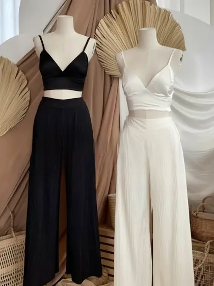 This is for those who love clean, modern lines. I designed these chic co-ord sets featuring a simple bralette top and matching wide-leg pleated trousers. Available in classic black and white, each set is tailored to your measurements for a comfortable yet polished look.