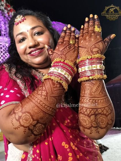 The joy on a client's face is the best reward. Here is the groom's sister, happily showing off her intricate mehndi, complete with traditional Rajasthani bangles.