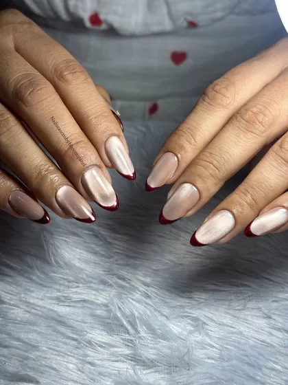 The cat eye effect on the nude base adds a modern twist to this classic French manicure.