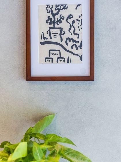 A bright and beautiful setting for your meal at Camillo's, with simple art and green plants adding to the warm atmosphere.