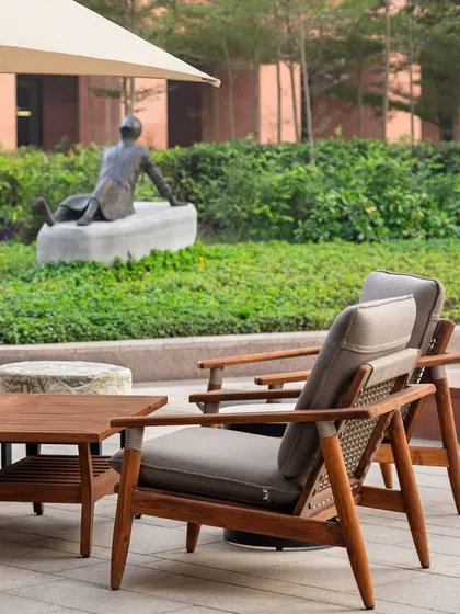 The outdoor lounge at Elevate, where a sculpture by Mukul Goyal creates a contemplative focal point. The design thoughtfully integrates art, nature, and comfort to enhance the resident experience.