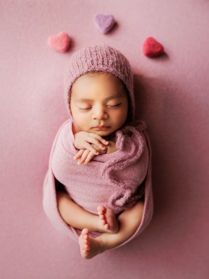 Simple and sweet. A baby in a pink wrap and bonnet, with a few felted hearts to add a touch of love to the scene.