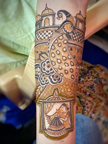 A full arm design featuring a bride in a jharokha (window) and a large, detailed peacock. This combination of portraiture and traditional motifs creates a rich and balanced design.
