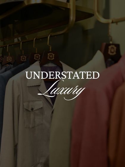 A rack of our jackets in muted tones, embodying the concept of understated luxury. These pieces are designed to be timeless, not trendy.