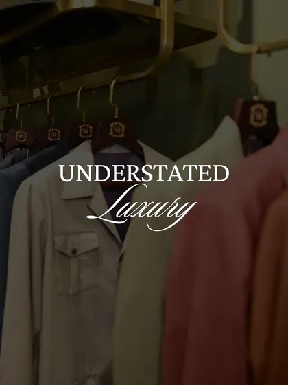 A rack of our jackets in muted tones, embodying the concept of understated luxury. These pieces are designed to be timeless, not trendy.