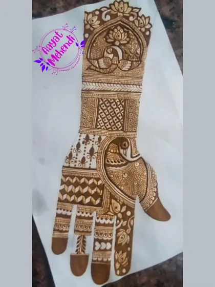 A full-hand design featuring peacock motifs, sketched on paper. This is a great way to plan out a complex bridal design.