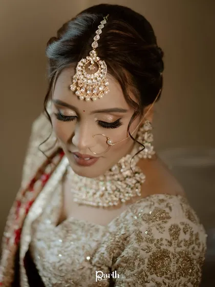A close-up on the bride's soft and glowing makeup, with a focus on her beautiful eyes.