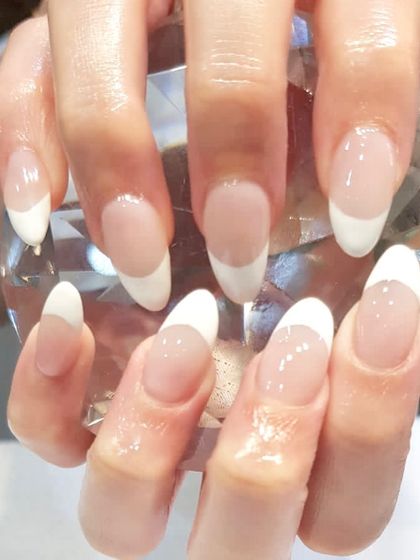 Classic elegance at its best. This is a beautiful example of a traditional French manicure on elegant, almond-shaped nails.