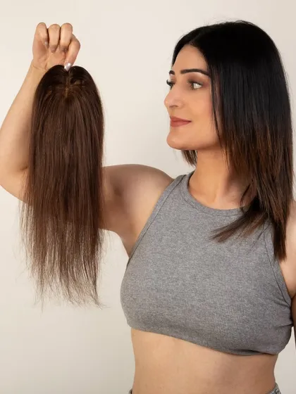 A side view of a model holding the hair topper, giving a sense of its length and texture.