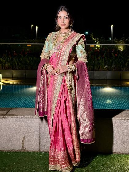 Posed by the water, the lighting catches the beautiful sheen of the saree and the luminous quality of her skin.