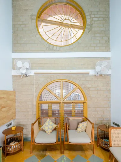 The double-height living space with its large windows that frame the view.