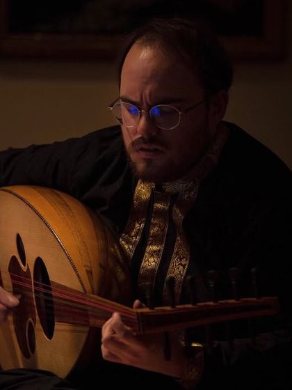 A musician playing the Oud, a stringed instrument central to Middle Eastern and Arabic music. This adds another rich layer to the cultural tapestry of our 'Sangam, Confluences' program.