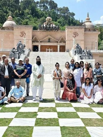 A group photo in front of a beautiful temple in Himachal.
