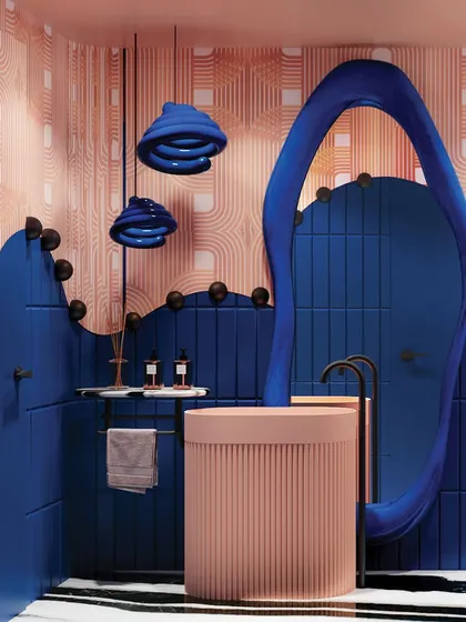The vanity area in this bathroom is a work of art, with a sculptural blue mirror, a fluted pink basin, and whimsical blue pendant lights.