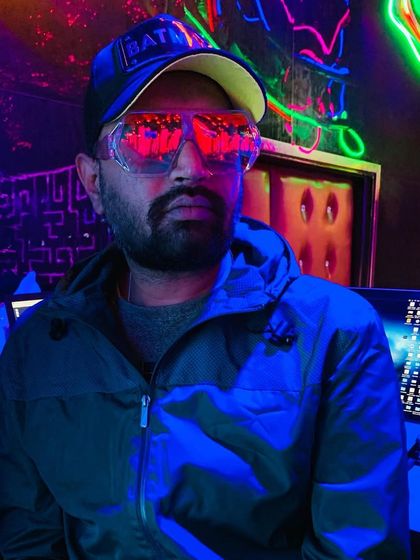 A cool, futuristic shot with neon lights reflecting in my glasses. The vibe of the venue is everything.