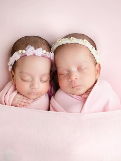 To the most adorable duo. Tucked in together under a soft pink blanket, these twin girls look so peaceful and content.