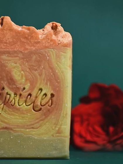 A close-up of the Rose & Rosewood soap. The vibrant hues come from French Green clay and Rose clay, which nourish the skin and leave it feeling soft and radiant.