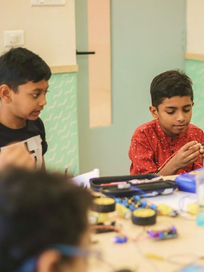 Another shot of Aethen and his friend working together, demonstrating the collaborative spirit we encourage in our robotics and STEM programs.