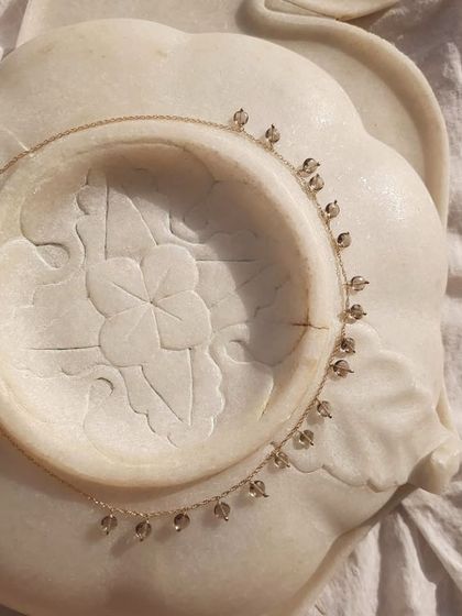 A beautiful flat lay of my Smoky Quartz Coin Choker. I designed this piece to gently neutralize negative vibrations and bring a sense of calm.