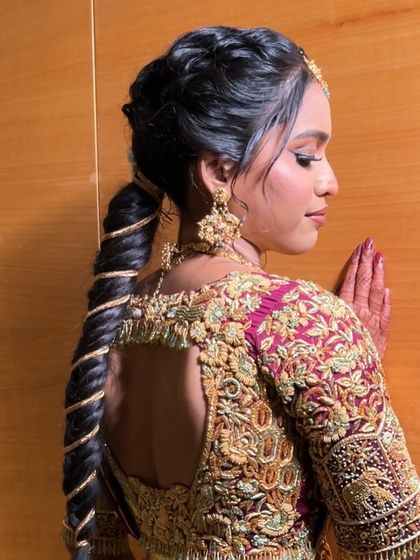 A side view of a unique spiral-wrapped ponytail braid, a very modern and sleek bridal hairstyle.