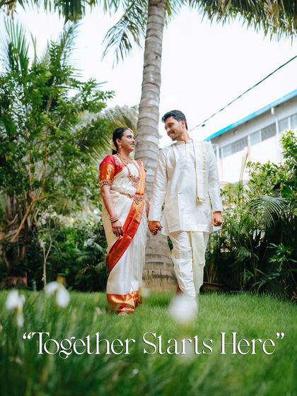 A low-angle shot of the couple walking hand-in-hand in a garden setting, creating a sense of intimacy and focusing on their connection.