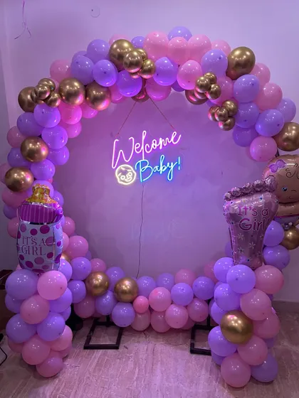 A 'Welcome Baby' balloon ring for a baby girl. The pink and purple balloons, along with 'It's a Girl' foil balloons, make for a lovely home decoration.