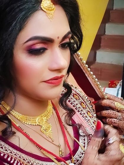 This side profile highlights not just the makeup but also the traditional henna on her hands and the way the dupatta is set. I help with the full look, ensuring every detail is perfect.