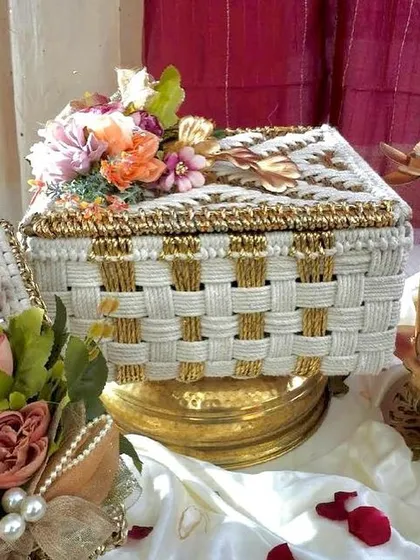 The lidded version of our white and gold woven basket, perfect for keeping the surprises inside safe. The floral arrangement on top adds a touch of elegance.