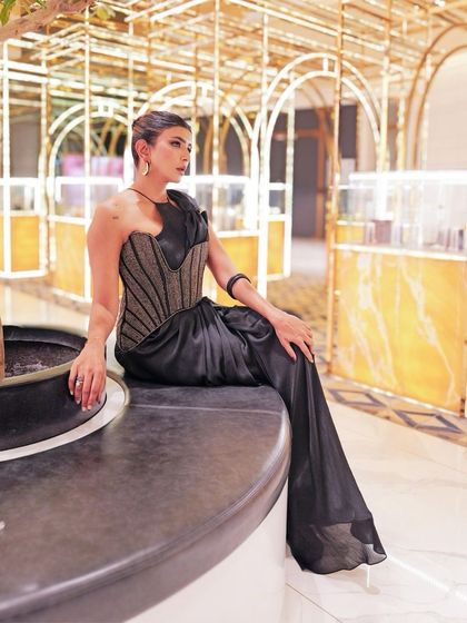 Lakshmi Manchu in the Nexus pre-stitched sari. The satin drape is paired with a sculpted blouse and an asymmetrical corset belt, blurring the lines between a sari and a gown.