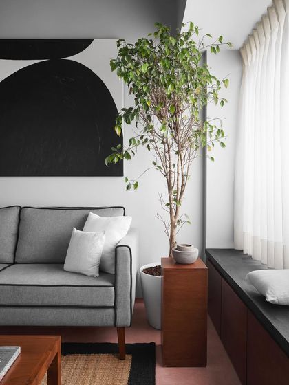 A custom sofa and built-in window seat provide ample seating in this living room. I designed the space to feel open and bright, with furniture that is both comfortable and stylish.