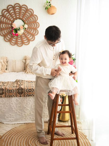 A playful moment between father and daughter. I encourage these natural interactions to capture the genuine joy and love within a family.
