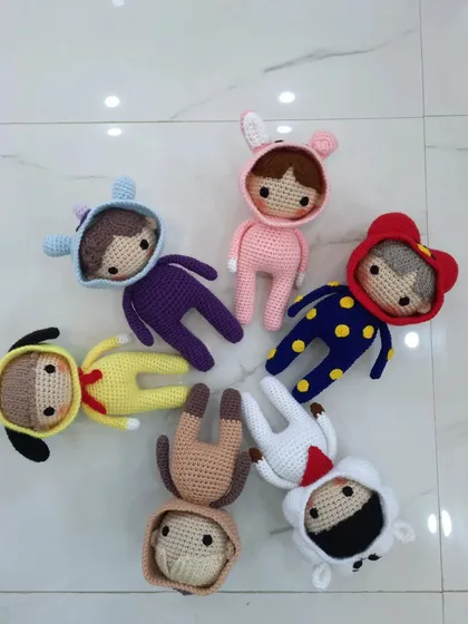 A top-down view of the crochet BTS doll collection, ready to be shipped to a fan.