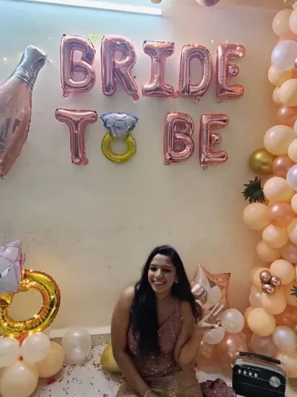 The happy bride-to-be enjoying her party in the decorated space we created for her at home.