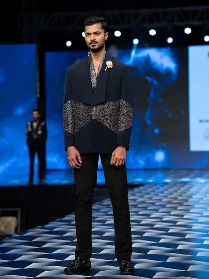 A poised moment on the ramp at Mysore Fashion Week for designer Pankaj Soni. The structured jacket with intricate detailing required a strong, grounded presence.
