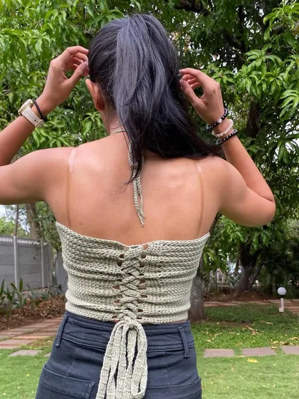 A view of the adjustable lace-up back on our criss-cross top. This detail ensures the top fits you perfectly and adds a stylish touch to the open-back design.