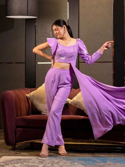 This shot captures the dramatic flair of a lavender co-ord set with a long, flowing side panel. The movement adds life to the studio shot, perfect for showcasing unique design features.