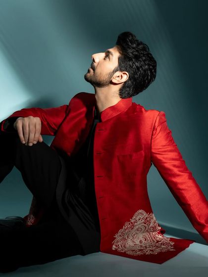 A seated portrait from the same series, with the subject looking up, creating a dramatic and aspirational feel.