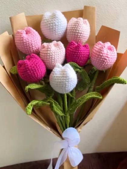 A charming and everlasting gift, this hand-tied bouquet is made entirely of handcrafted crochet tulips in shades of pink and white. Wrapped in simple brown paper, it's a unique piece of art that lasts forever.