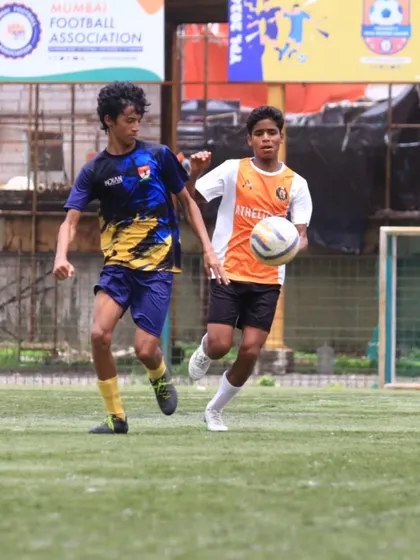 A player on the move, dribbling past the opposition with speed and skill.