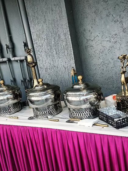 A corporate event catering setup for A4 Electricals in Gurgaon. The vibrant pink table skirting and decorative elements add a pop of color to the professional setting.