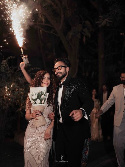 The couple makes a sparkling entrance to their reception, complete with a cold pyro fountain. I love capturing the energy and excitement of these big moments.