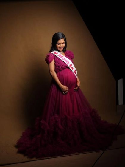 Accessorize your maternity look with a "Mom to be" sash. This client looks radiant in my magenta tulle gown during her baby shower photoshoot.