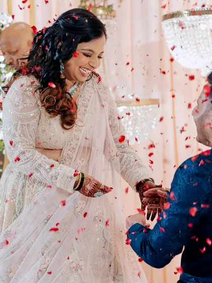 A magical moment during the ring exchange. The bride looks joyful and radiant in her lehenga, ready to dance the night away.