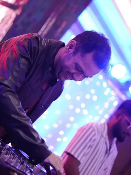Sharing a smile while mixing at a large event. I genuinely have fun while I'm performing, and I believe that positive energy is contagious.