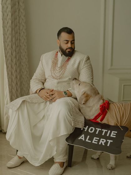 Even the furry family members get in on the action. This adorable shot of the groom, Vikash, with his dog (the "hottie alert") is a heartwarming and personal moment that shows a different side of the wedding day.