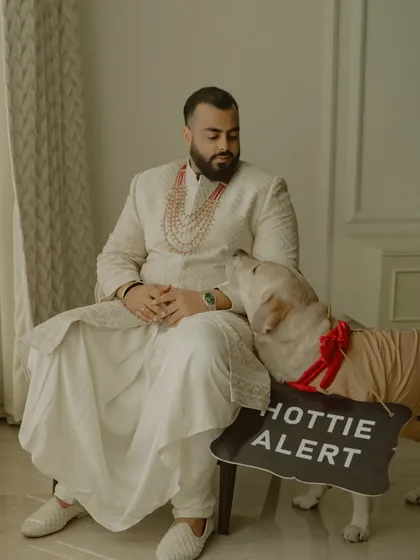 Even the furry family members get in on the action. This adorable shot of the groom, Vikash, with his dog (the "hottie alert") is a heartwarming and personal moment that shows a different side of the wedding day.