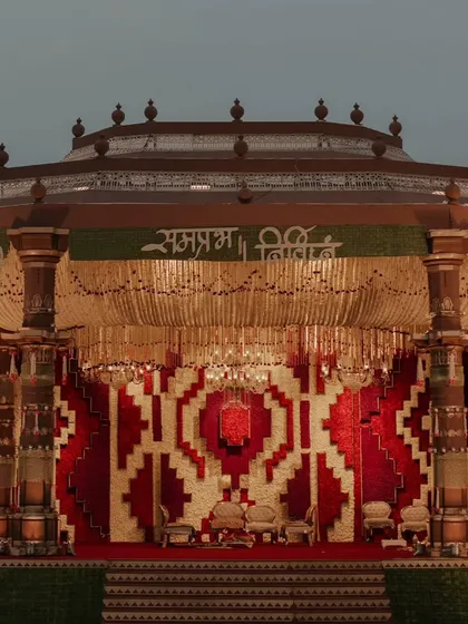 A full view of the magnificent Dwarka-inspired mandap structure, showcasing its architectural grandeur and the intricate floral backdrop.